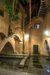 Medieval public laundry in Cefalu at night. This is one of the main tourist attraction. Cefalu, Sicily, Italy.