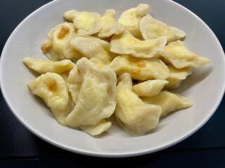 Dumplings with cheese on a gray plate