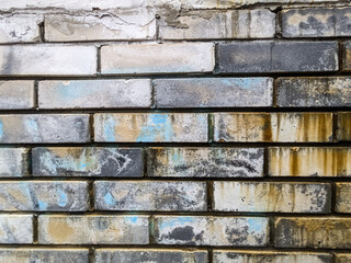 Brick background. Wall of bricks with fragments of graffiti. Background of light brick.