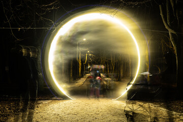 Illuminated portal with fog and smoke in the middle of the road