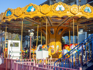 Amusement park in a residential area. Fun for kids. Carousels in the city park.