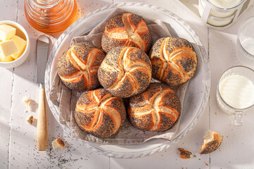 Homemade Kaiser buns with poppy seed in white basket. - 749617583