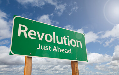 Revolution Just Ahead Green Road Sign Over Clouds and Blue Sky.