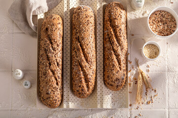 Tasty wholegrain baguettes baked on a special baking tray.