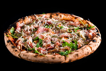 Italian lunch pizza with bacon, cheese, arugula and sauce isolated on black.