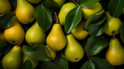 Background from fresh ripe pears with green leaves, top view