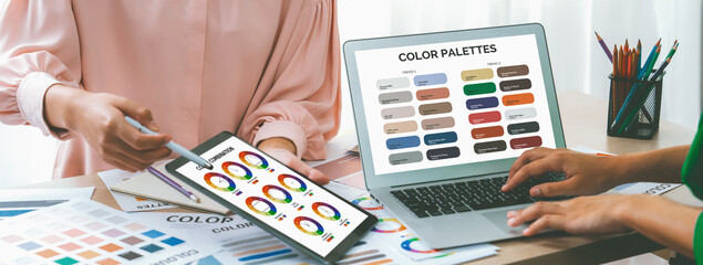 A cropped picture of professional designer selects the color by using color theory while using...