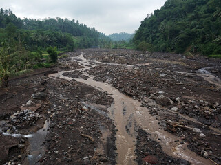 A view of the valley after the volcanic eruption. A mud river has demolished houses. A natural disaster