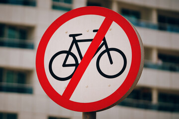 A red and white traffic sign with bold font that prohibits bicycles from entering. The sign specifically states No bicycles allowed to prevent any twowheeled vehicles from using the road