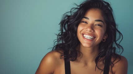 Smiling happy attractive hispanic young woman posing in studio shot - obrazy, fototapety, plakaty