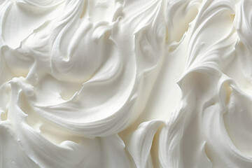 A close-up view of white whipped cream on a plate