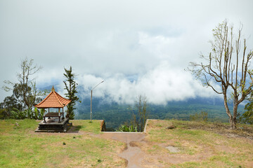 The gazebo stands on a cloud-shrouded mountain on the popular tourist island of Bali.