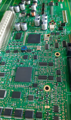 Close-up of electronic circuit board  with components: microchip, processor, integrated circuits, capacitors