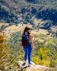 Naklejka premium backpacker enjoys the panorama of mount barney national park and lake maroon from the summit of mount may; hiking mountain in south east queensland, australia