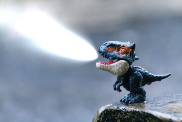 Dinosaur action figure shoots lasers from mouth during heavy rain
