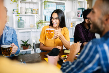 Young group of friends having breakfast or brunch sitting at restaurant table. Food and drink concept. - obrazy, fototapety, plakaty