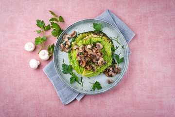 Traditional savoy cabbage lasagne with mashed potatoes and mushrooms served as top view on a design plate with text space