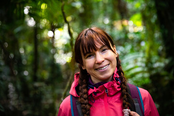 portrait of beautiful smiling girl in tropical rainforest in australia, albert river cirquit;...
