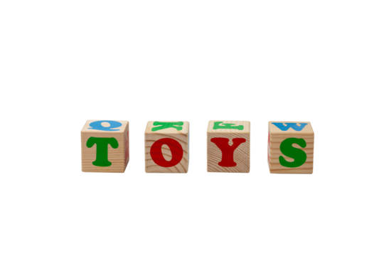 Children's wooden cubes with red and green letters with the word toys next to them. No background. High quality photo.