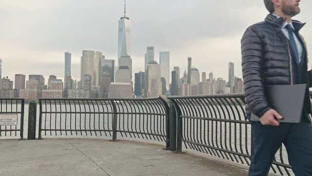 Serious business man in autumn jacket walk outside. Businessman walking on the street in New York. Gray businessman with beard in business suit in NY city street. Manager near Manhattan street.