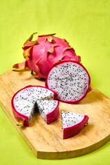 Red dragon fruit Set with appetizing serving on green background. Top view