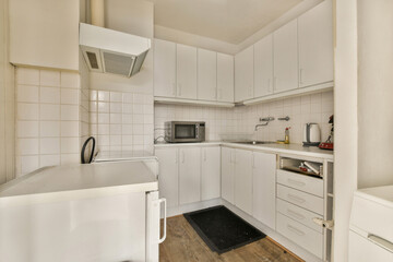 a small kitchen with white cabinets and a counter top