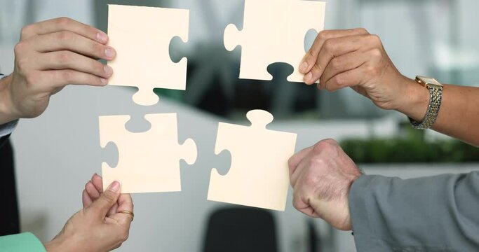 Close up hands hold puzzle pieces connecting together, showing challenges, problem-solving, engaged in teamwork, share tips and strategy. Successful business synergy, find right solution, support sign