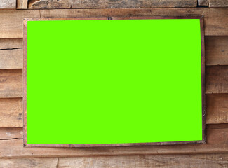 green blank frame on wooden background