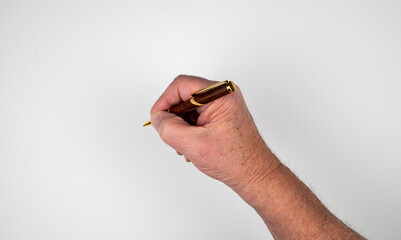 Caucasian male hand holding wood cased ball point pen on white background