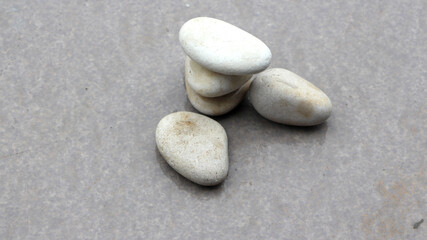 Fototapeta na wymiar Pile of fine textured gravel, natural stone, on top of watery black stone