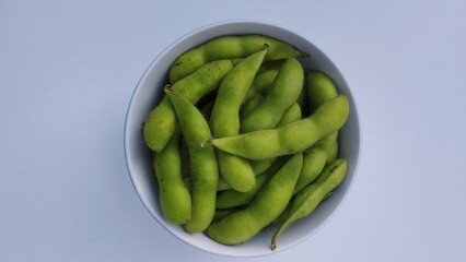 green soy beans in a bowl isolate on white