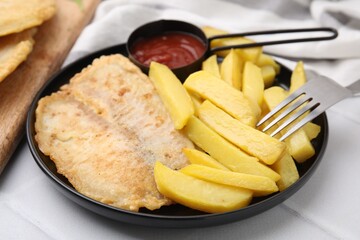 Delicious fish and chips served on white table, closeup