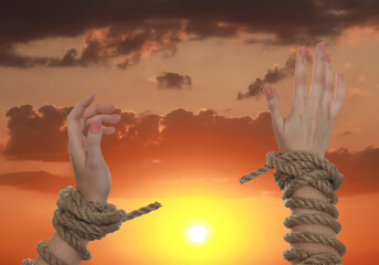 Freedom. Woman with ripped ropes against sky at sunset, closeup
