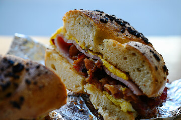 Garlic bagel with egg and bacon, unwrapped from foil package