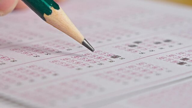 answer sheet, crossing out correct answers with pencil for testing