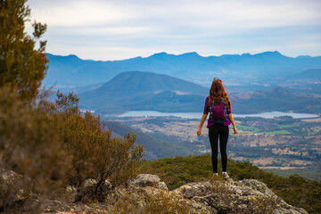 hiker girl admiring the panorama of mountains on the way to the top of mount maroon, mount barney...