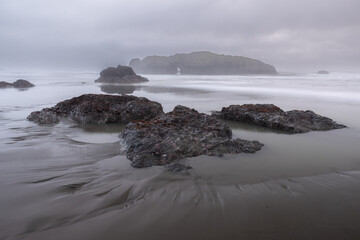 A rocky beach with a gray sky in the background