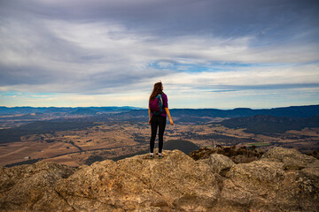 backpacker girl admiring the panorama of mountains in mount barney national park from the summit of...