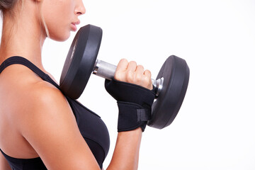 Sports girl with dumbbells in her hands on a light background - 749681105