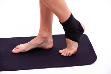 Sports female legs in an elastic medical bandage