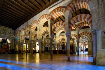 Inside the ornate and arched Hypostle Prayer Hall of the great Mosque Cathedral Mezquita in the...