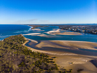 sunset over north bribie island and caloundra in south east queensland, australia; people passing to the island during low tide; Pumicestone Passage	