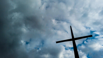 Wooden cross on the right side with sky in the background in Bogotá