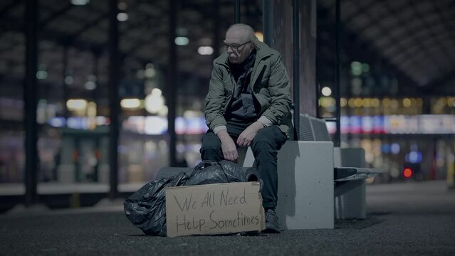 Elderly Homeless Man Suffering from Poverty Looking for Help at Train Station
