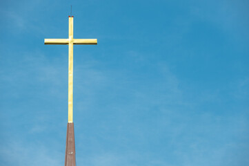 The Christian cross against blue sky. The cross is accepted as the most popular symbol of Christianity.