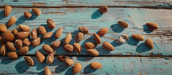A cluster of almonds is neatly arranged on top of a wooden table, showcasing their natural texture and color. The light shines on the almonds, giving them a warm and inviting appearance.