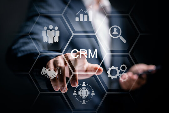 CRM, Customer relationship management concept. Businessman touch CRM icons on virtual screen. Customer network management and development of customer information exchange, social media, digital online