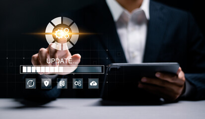 Software update or operating system upgrade. Improved functionality in the new version and improved security. Businessman touching update icon on virtual screen.