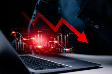 Economic crisis and global economic recession. Economic stagnation and inflation, Business investment risks. Businessman using laptop to analyze economic graph.