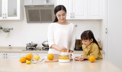 Asian mother making fresh juice with her daughter